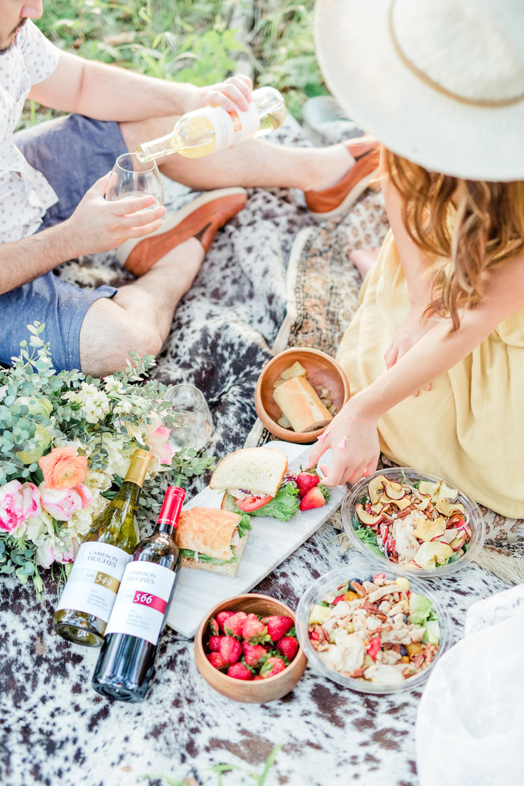 A couple enjoys a wine-paired meal while glamping