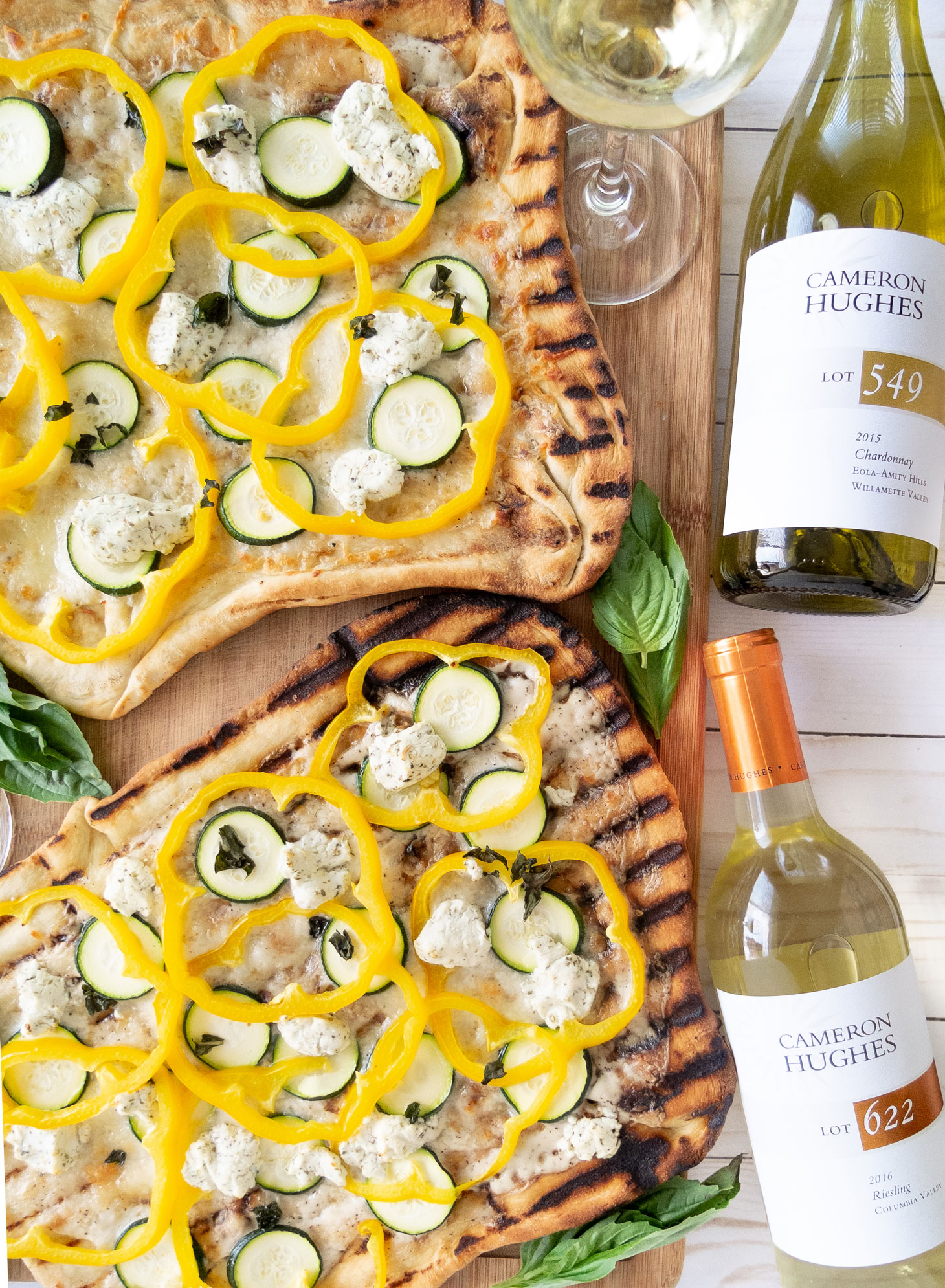 Two freshly grilled Summer pizzas paired with white wine