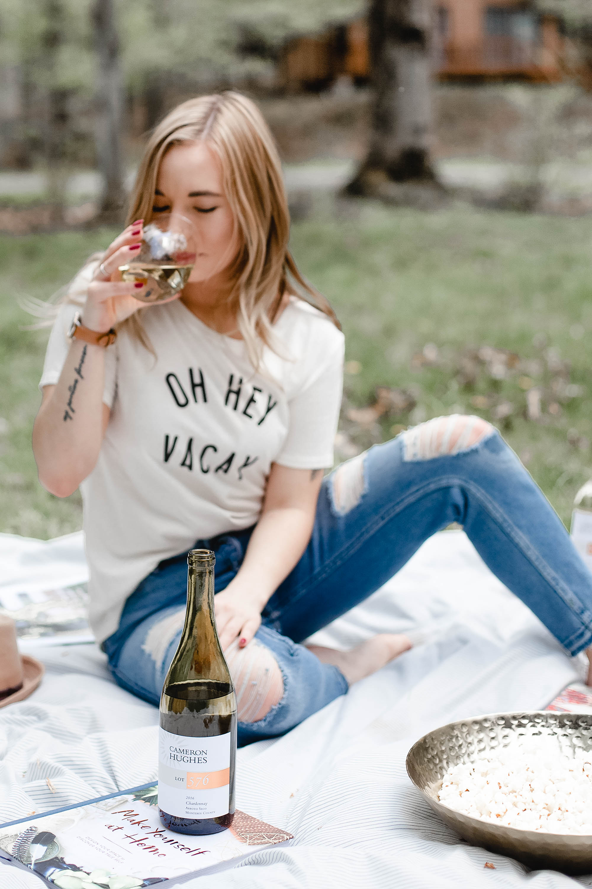 Girl sipping wine from Cameron Hughes Wine in an Oh Hey Vacay T-Shirt