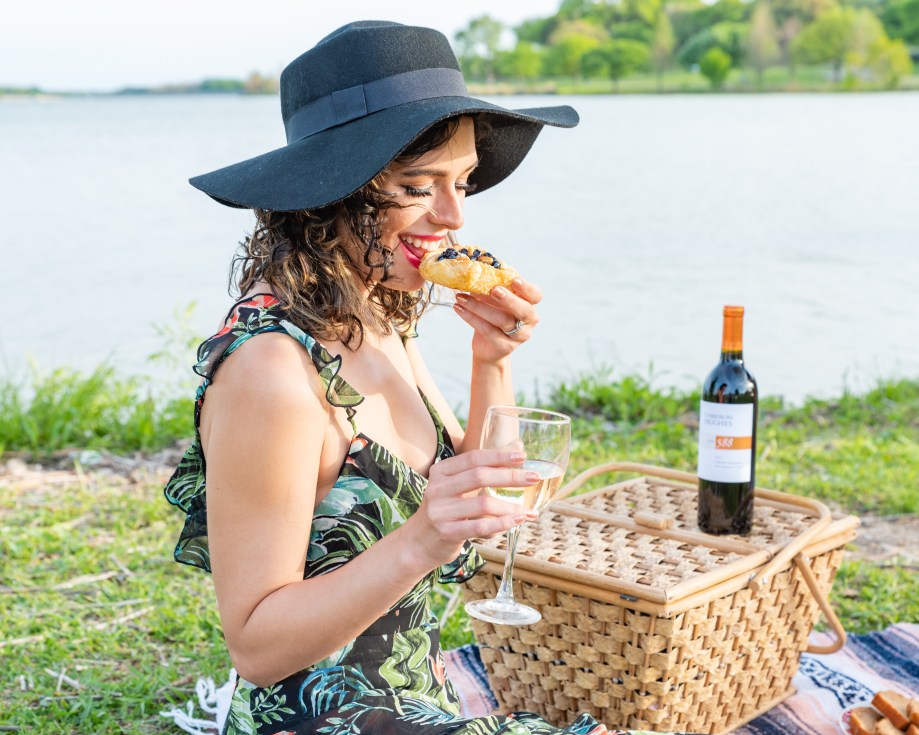 Woman taking a bite of a wine-paired morsel