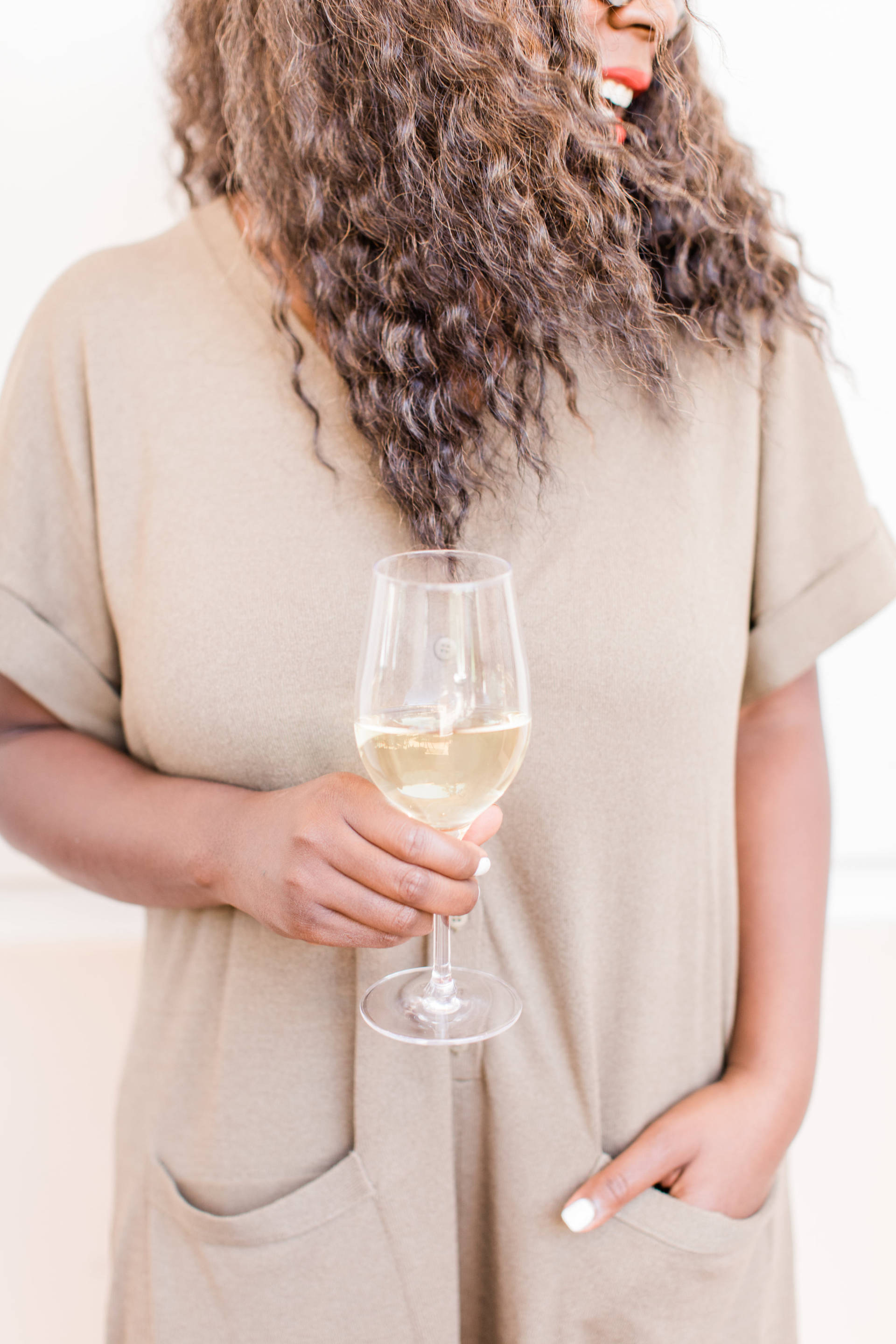 A woman wearing a shirt that almost matches her Cameron Hughes white wine