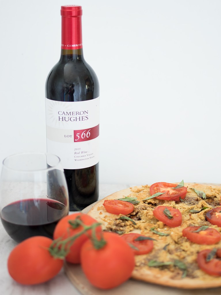 Cameron Hughes Lot 566 red wine bottle with a glass poured, paired with caprese pizza