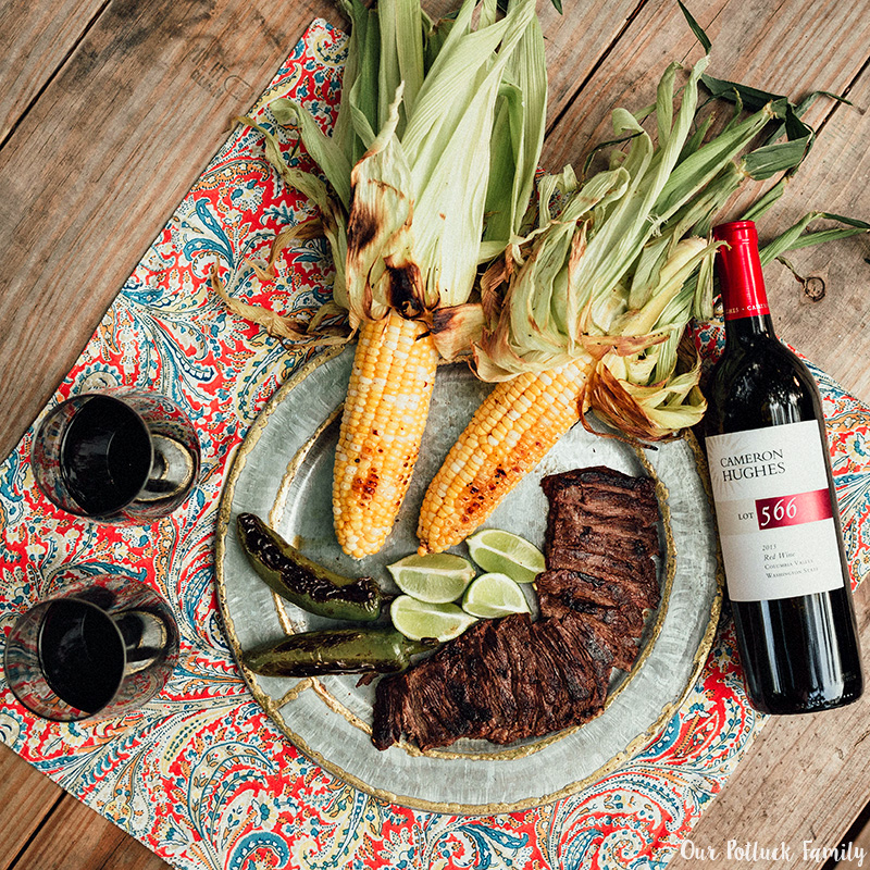 Steak and fresh corn on the cob paired with red wine