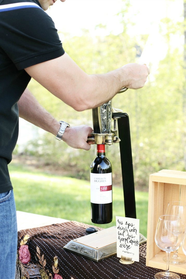 Professional wine bottle opener with a bottle of Cameron Hughes wine being opened