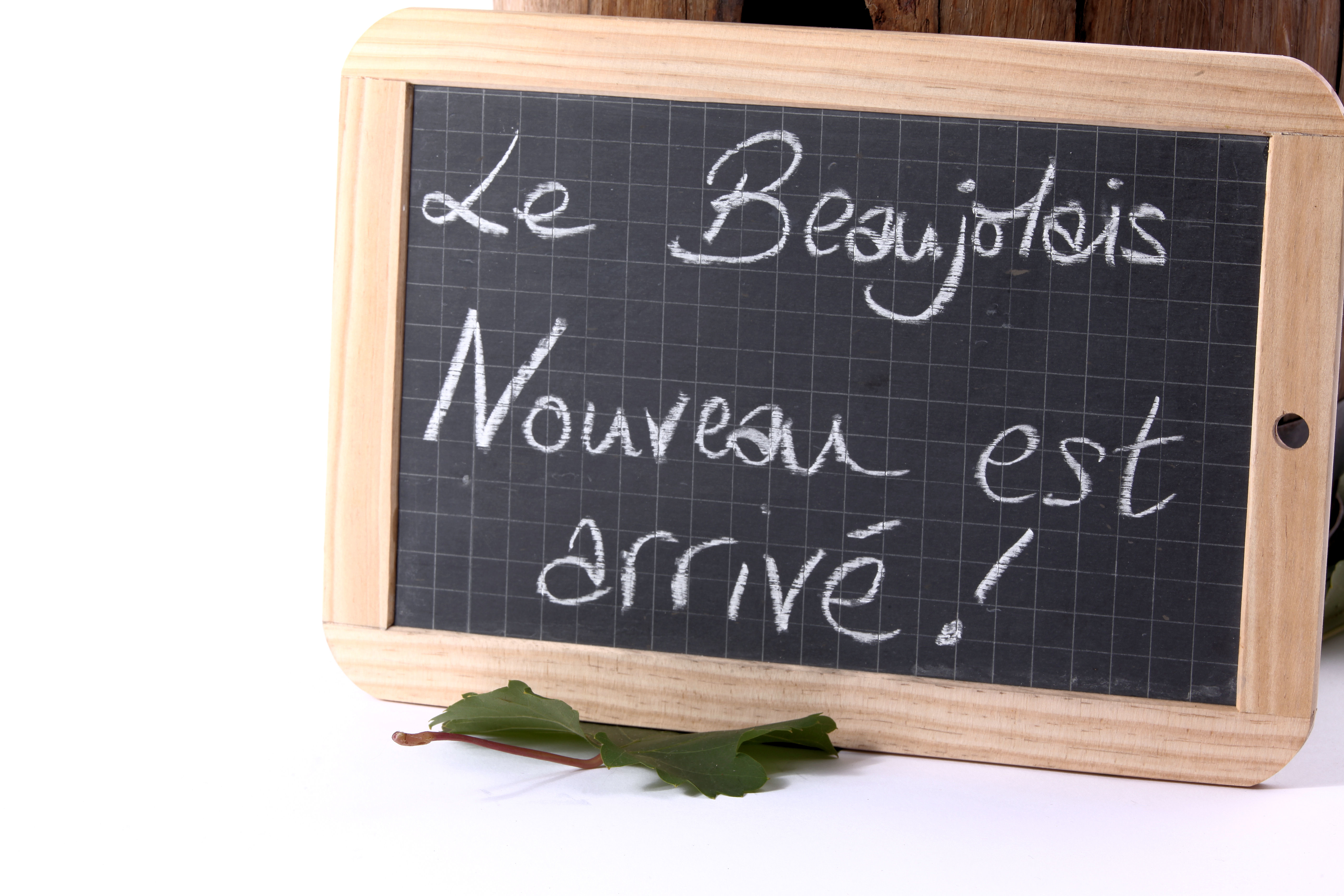 A chalkboard sign reading Le Beaujolais Nouveau es arrive!