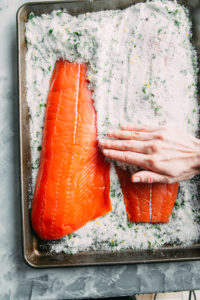 Salmon being removed from a salt rub
