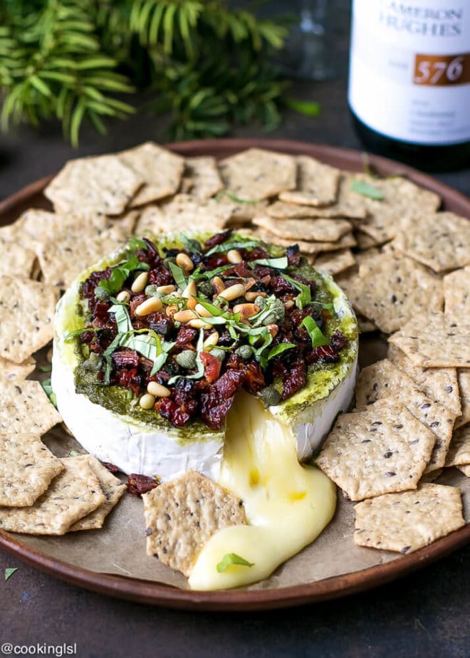 Savory baked brie appetizer with crackers paired with wine
