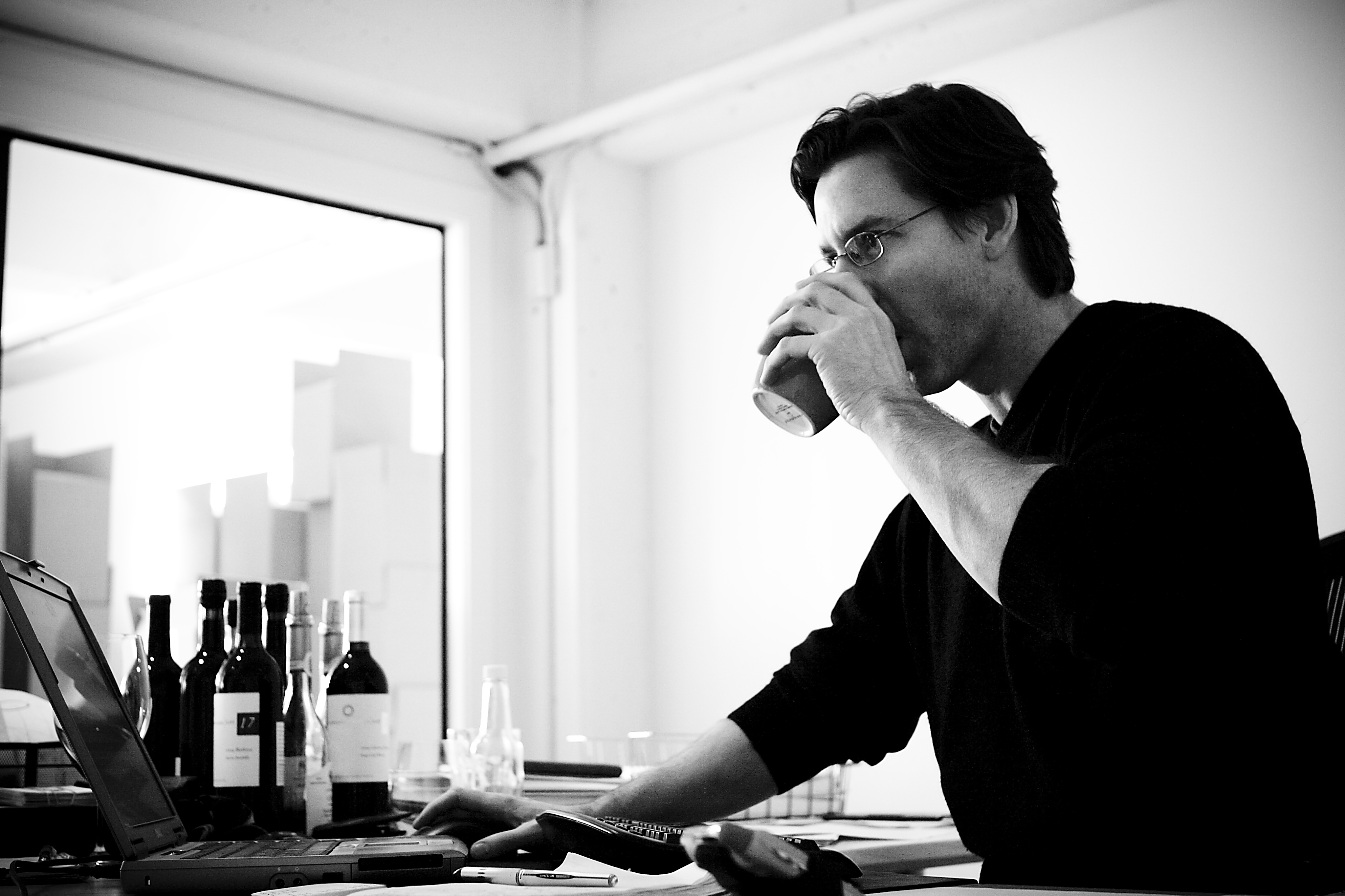 Black and white photo of man drinking wine from a Solo cup