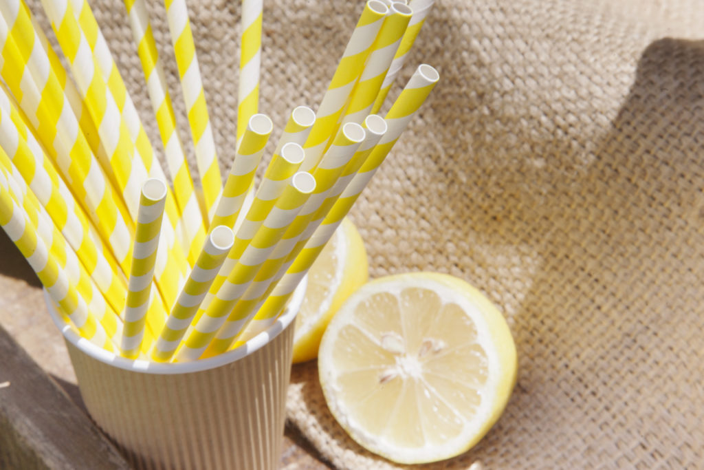Colorful straws in a cannister for sipping Mimosas made from sparkling wine