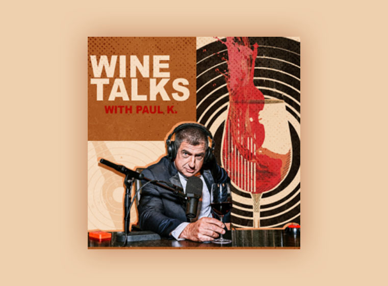 Wine Talks with Paul K shows host holding a glass of wine with artwork in background